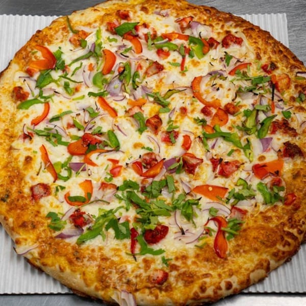 Moon Pizza's chicken tikka pizza with red onions, bell peppers, and cilantro.