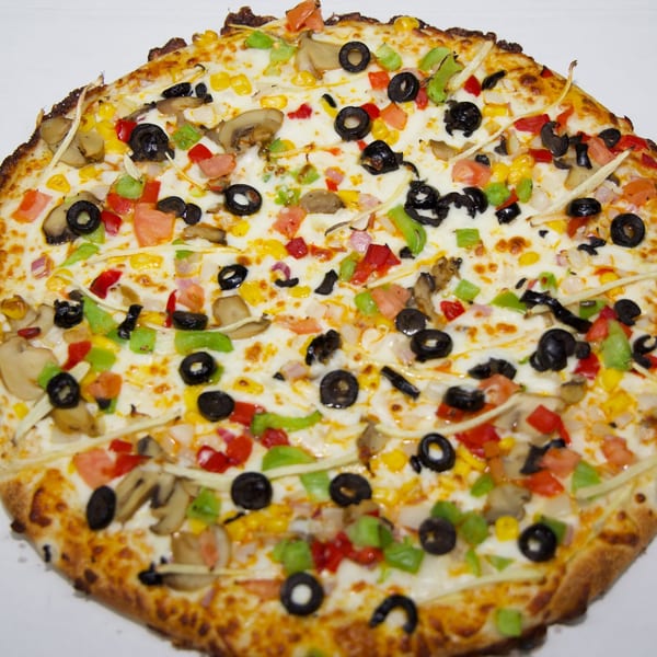 Moon Pizza's vegetarian pizza, topped with olives, mushrooms, corn, and bell peppers.