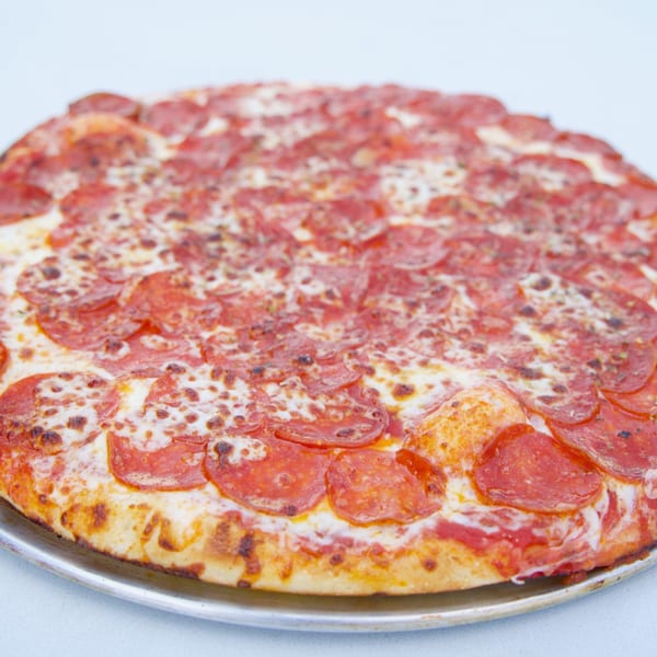 A large, round pepperoni pizza from Moon Pizza, with melted cheese and a golden crust.
